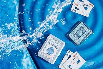 Poolside Edition waterproof plastic cards being rinsed under water faucet demonstrating cleaning and waterproof durability