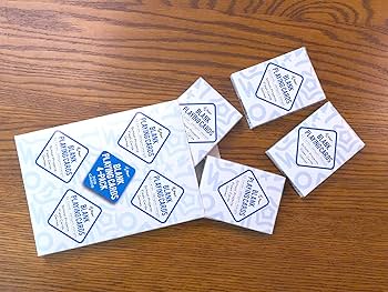 Blank white playing cards on a wooden table with markers ready for DIY customization